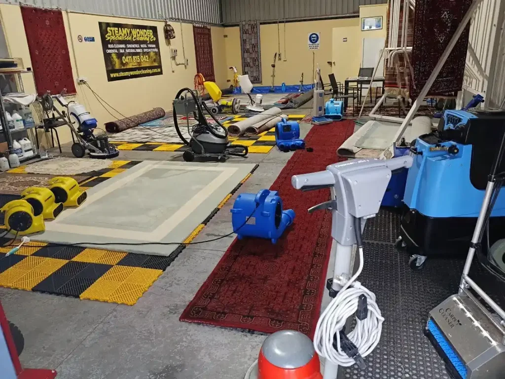 Professional carpet and rug cleaning workshop with extraction machines and air movers, how to get your bond back