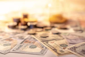 Cash notes and coins spread across a table, how to get your bond back